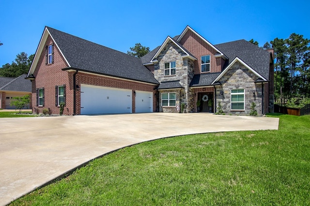 craftsman house with a garage, driveway, stone siding, a shingled roof, and a front yard