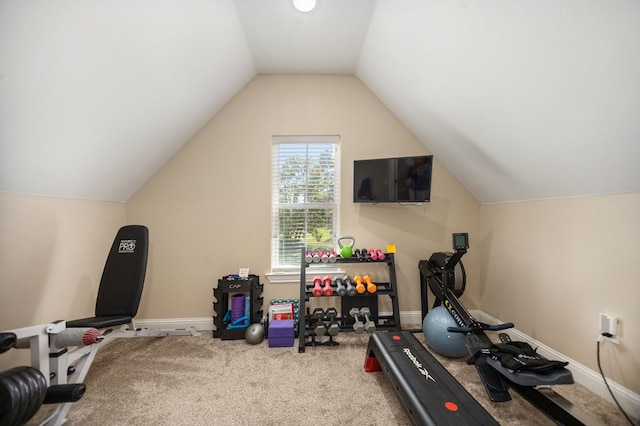 exercise area featuring lofted ceiling, carpet flooring, and baseboards