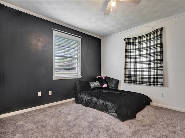 carpeted bedroom featuring baseboards, ornamental molding, and ceiling fan
