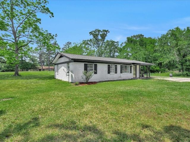 view of front facade with a front yard and brick siding