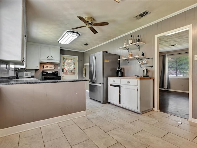 kitchen with under cabinet range hood, visible vents, ornamental molding, freestanding refrigerator, and electric range