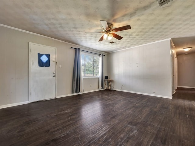 interior space featuring hardwood / wood-style floors, a ceiling fan, ornamental molding, and baseboards
