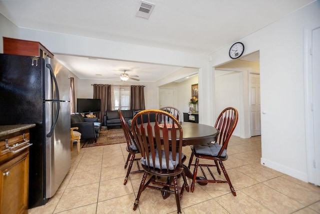 tiled dining space featuring ceiling fan