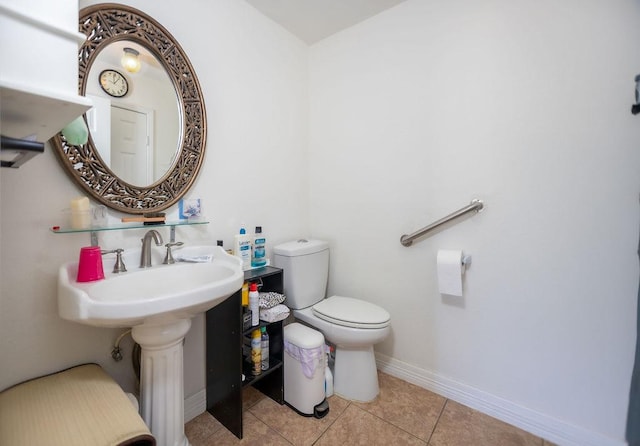 bathroom featuring tile patterned flooring and toilet