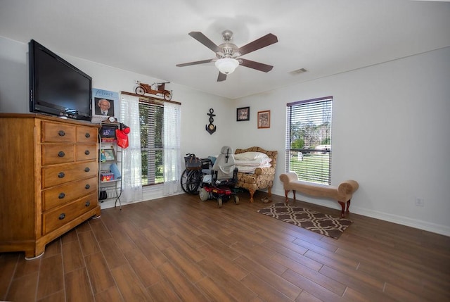 sitting room with dark hardwood / wood-style floors and ceiling fan