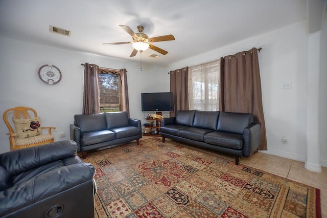 tiled living room featuring ceiling fan