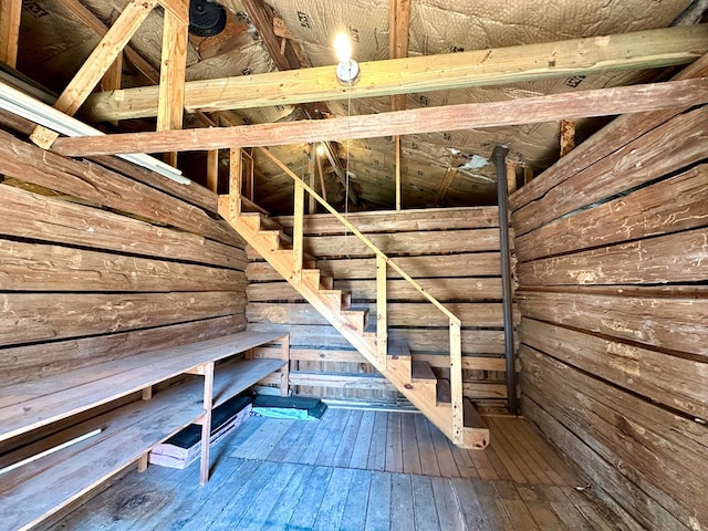 interior space with wooden walls and hardwood / wood-style flooring