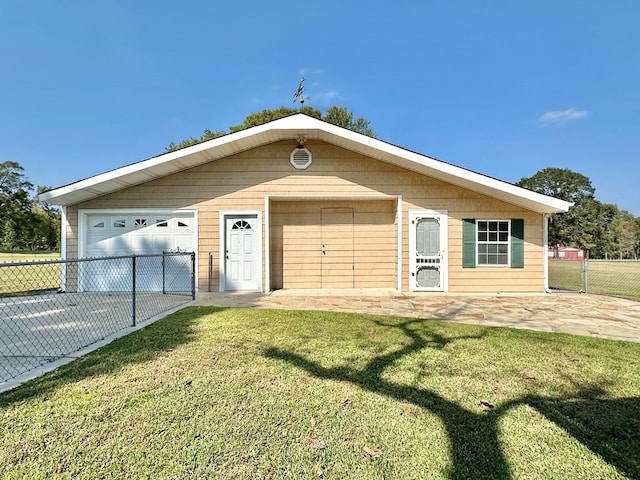 single story home featuring an outdoor structure, a front yard, and a garage