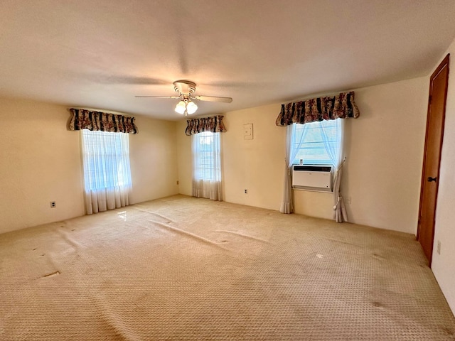 carpeted spare room featuring ceiling fan, cooling unit, and a textured ceiling