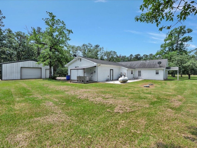 21441 Fm 705, Broaddus, TX 75929 - back of property featuring a garage, a yard, an outbuilding, and a patio area