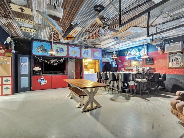 21441 Fm 705, Broaddus, TX 75929 - rec room with finished concrete floors, a dry bar, and a wall mounted air conditioner