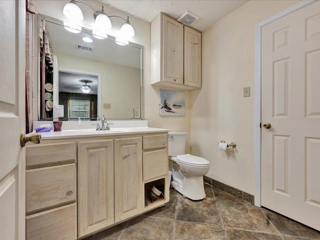 21441 Fm 705, Broaddus, TX 75929 - bathroom featuring vanity, toilet, and baseboards