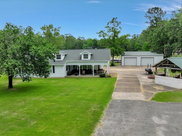 21441 Fm 705, Broaddus, TX 75929 - view of front of home with a detached garage, an outdoor structure, a front yard, a shingled roof, and view of scattered trees