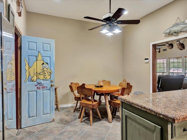 21441 Fm 705, Broaddus, TX 75929 - dining area featuring ceiling fan, light stone finish flooring, and baseboards