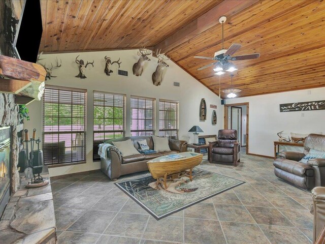 21441 Fm 705, Broaddus, TX 75929 - living area with wooden ceiling with exposed beams, plenty of natural light, baseboards, high vaulted ceiling, and a ceiling fan