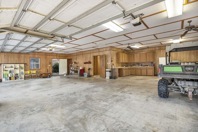 2101 Fm 1007, Brookeland, TX 75931 - garage featuring ceiling fan, wood walls, and a garage door opener
