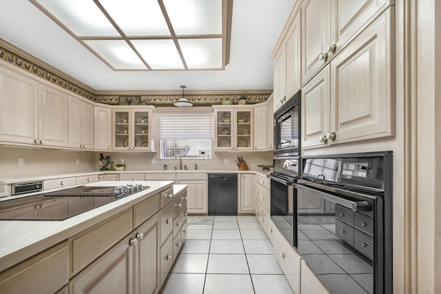 kitchen with black appliances, light tile patterned floors, and sink