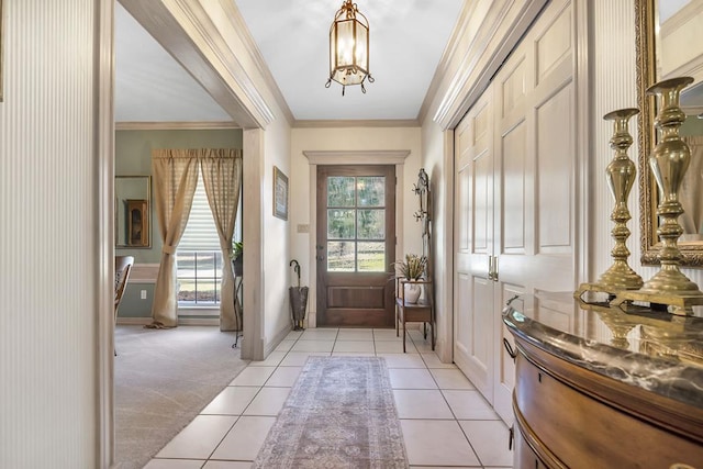 entryway with light tile patterned flooring, crown molding, and a chandelier