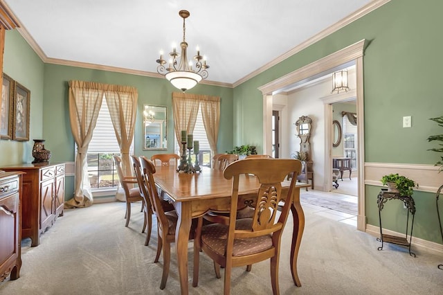 dining area with a notable chandelier, light colored carpet, and crown molding