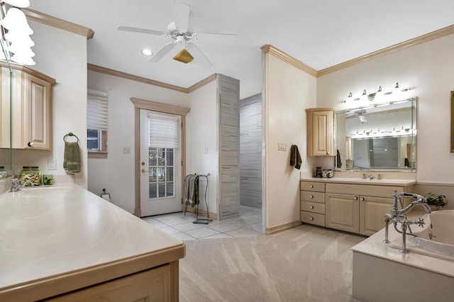 bathroom featuring a washtub, vanity, crown molding, and tile patterned flooring