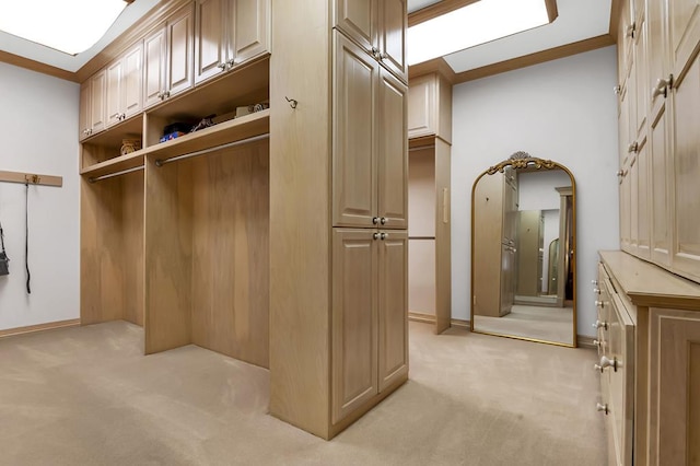 walk in closet with light colored carpet and lofted ceiling