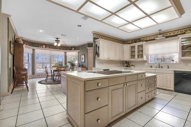 kitchen with a center island, black appliances, sink, ceiling fan, and ornamental molding