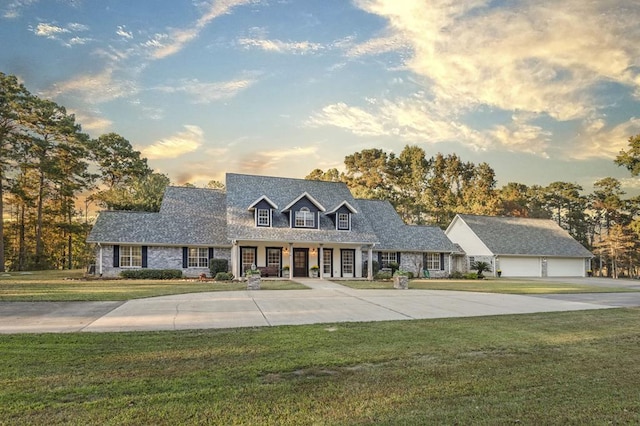 cape cod-style house with a lawn