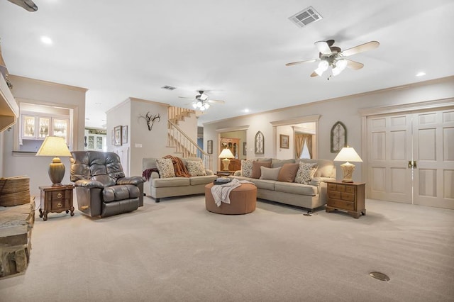 living room with ceiling fan, light colored carpet, and ornamental molding