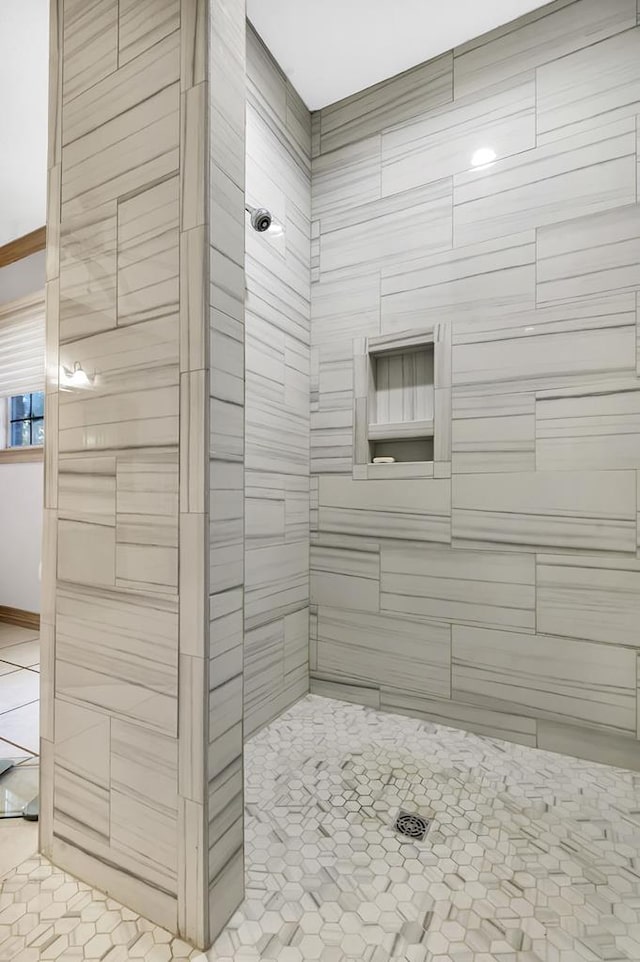 bathroom with a shower and tile patterned flooring