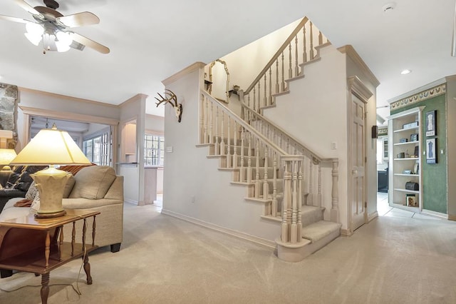 stairway featuring ceiling fan and carpet floors