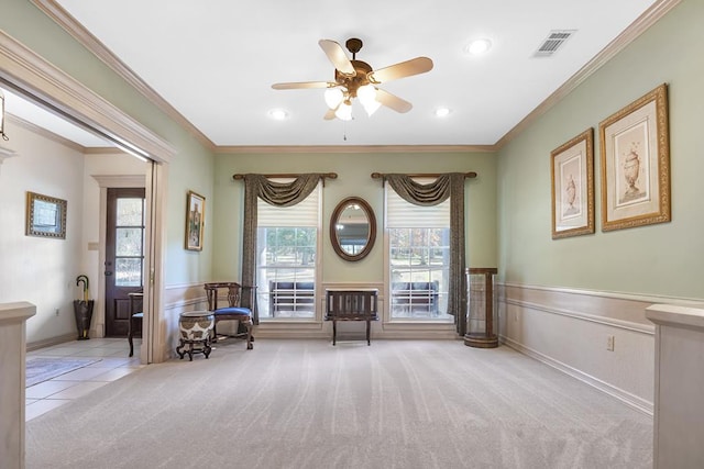 unfurnished room with crown molding, ceiling fan, and light colored carpet