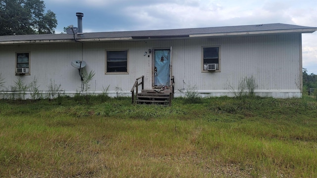 rear view of property with cooling unit