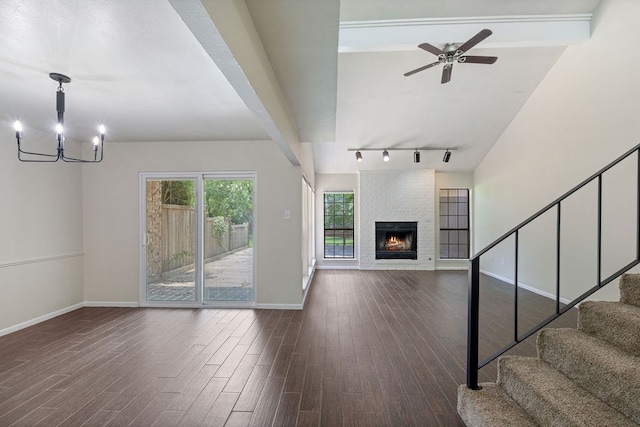 112 Westchester St, Lufkin, TX 75901 - unfurnished living room with track lighting, stairway, wood finished floors, and a chandelier