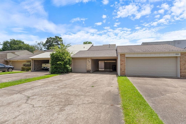 112 Westchester St, Lufkin, TX 75901 - townhome / multi-family property featuring brick siding, an attached garage, and driveway