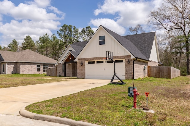 modern farmhouse style home with fence, concrete driveway, a front yard, a shingled roof, and brick siding