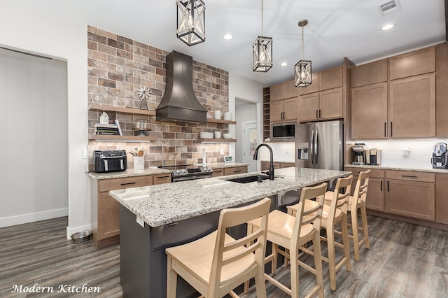 kitchen with open shelves, a sink, custom range hood, appliances with stainless steel finishes, and backsplash