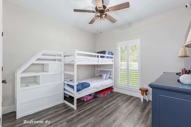 bedroom featuring ceiling fan, baseboards, and wood finished floors