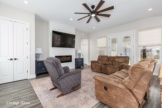 living room with baseboards, recessed lighting, a fireplace, french doors, and wood finished floors