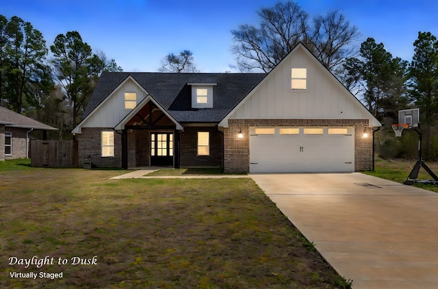 view of front of home with a front yard, driveway, roof with shingles, a garage, and brick siding