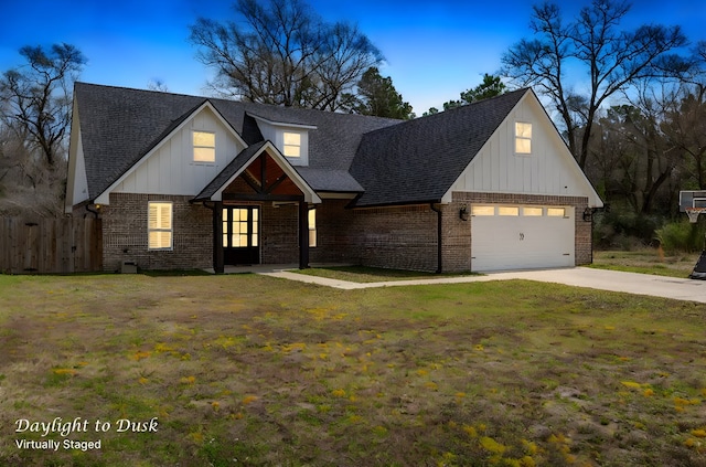 modern farmhouse featuring concrete driveway, fence, brick siding, and roof with shingles