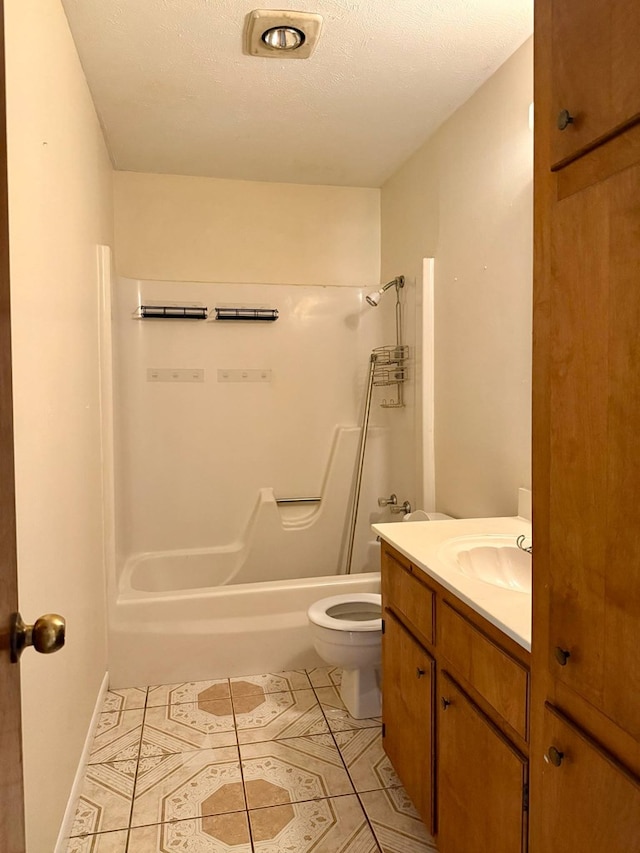bathroom featuring shower / washtub combination, vanity, tile patterned flooring, and toilet