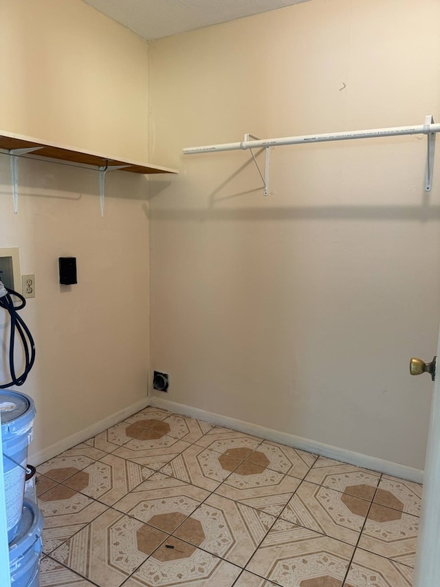 clothes washing area featuring hookup for a washing machine, baseboards, and laundry area