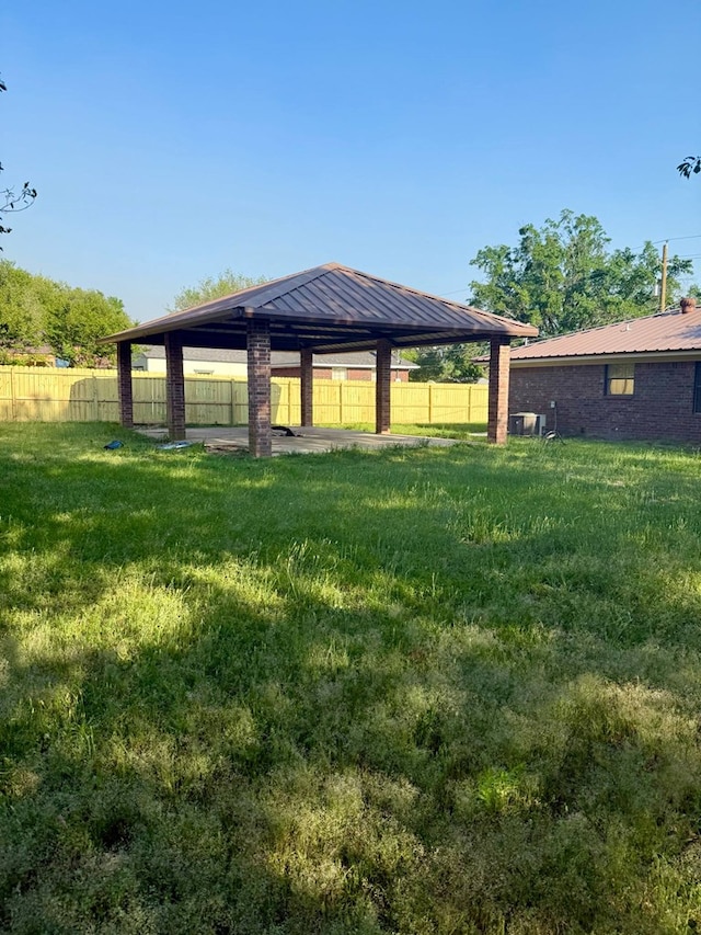 view of yard featuring fence and a gazebo