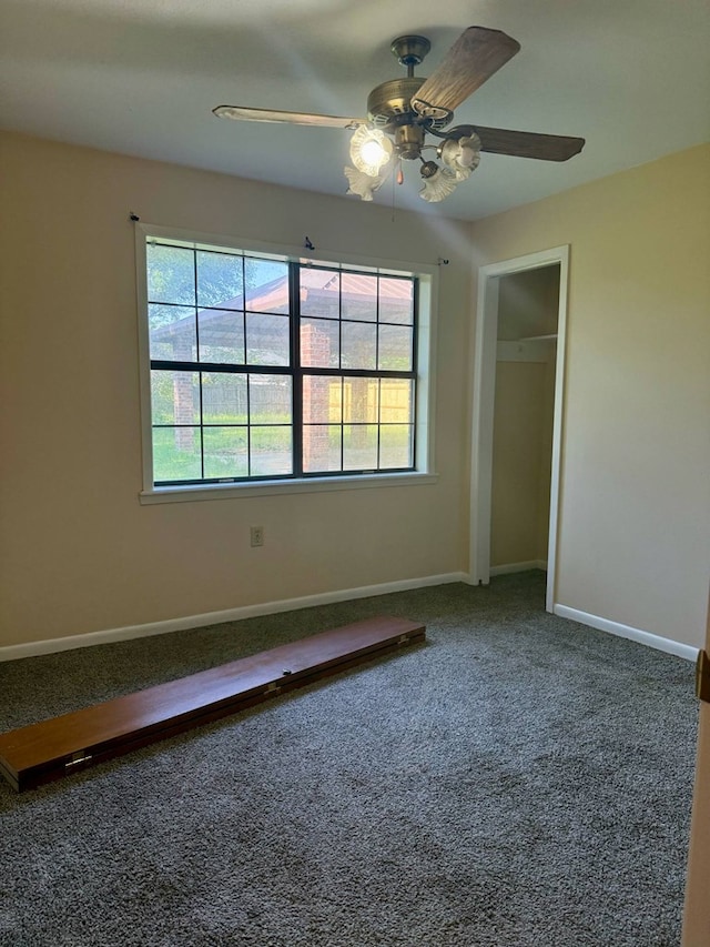 unfurnished bedroom featuring baseboards, carpet, and ceiling fan