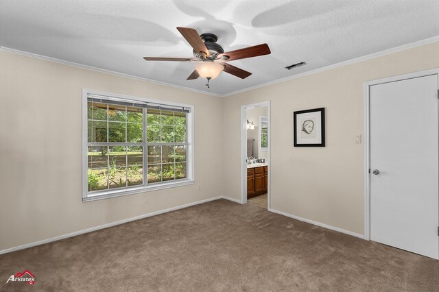 140 Eastwood Dr, Milam, TX 75959 - unfurnished bedroom with carpet, ornamental molding, baseboards, connected bathroom, and ceiling fan