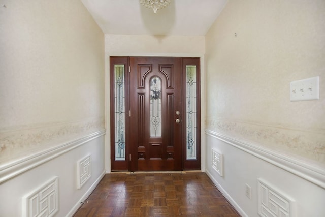 foyer entrance with dark parquet flooring