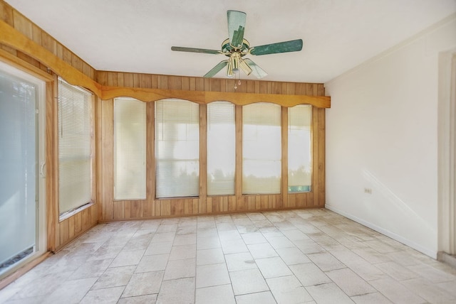 unfurnished sunroom featuring ceiling fan