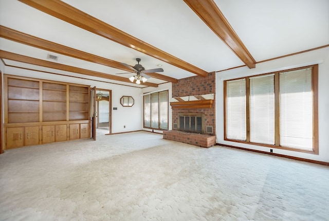 unfurnished living room featuring beamed ceiling, plenty of natural light, ceiling fan, and a fireplace