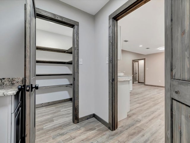 242 W Magnolia, Huntington, TX 75949 - corridor featuring baseboards and light wood-style floors