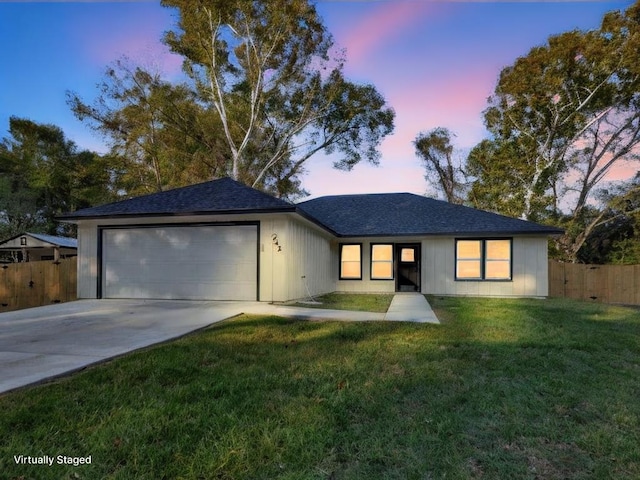 single story home with a garage, concrete driveway, a front yard, and fence